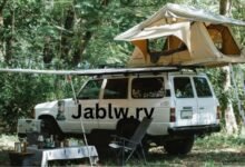 Jablw.rv parked in a scenic landscape, showcasing eco-friendly travel.